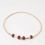 Cork necklace with reddish-orange ceramic and silver terminal