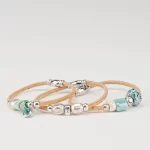 Three separate natural cork bracelets with ceramic and silver beads