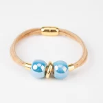 Natural cork bracelet with 2 turns, light blue ceramic balls and gold beads